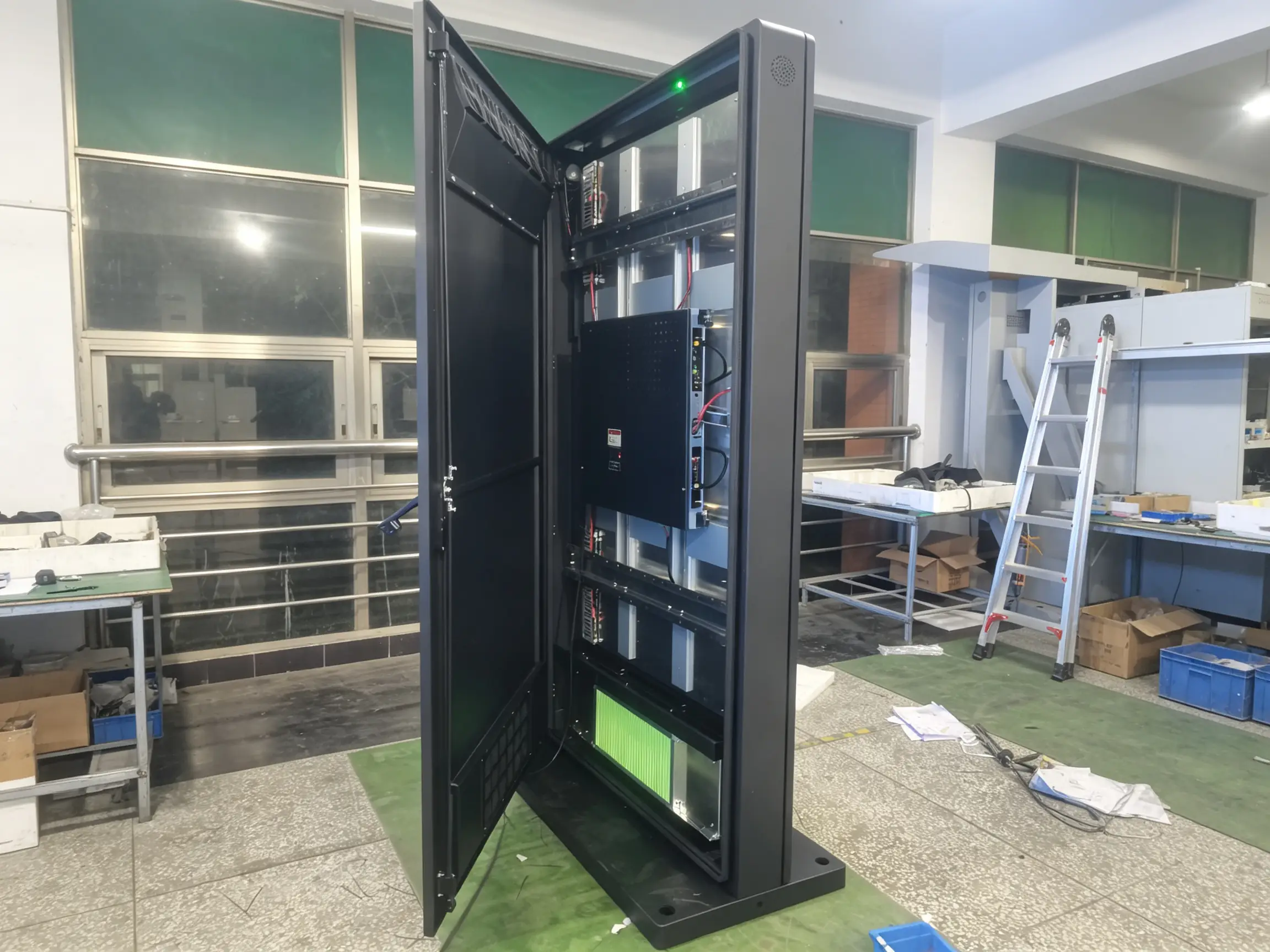 Weatherproof IP-rated enclosure with sealed cable entries for outdoor landscape digital signage.