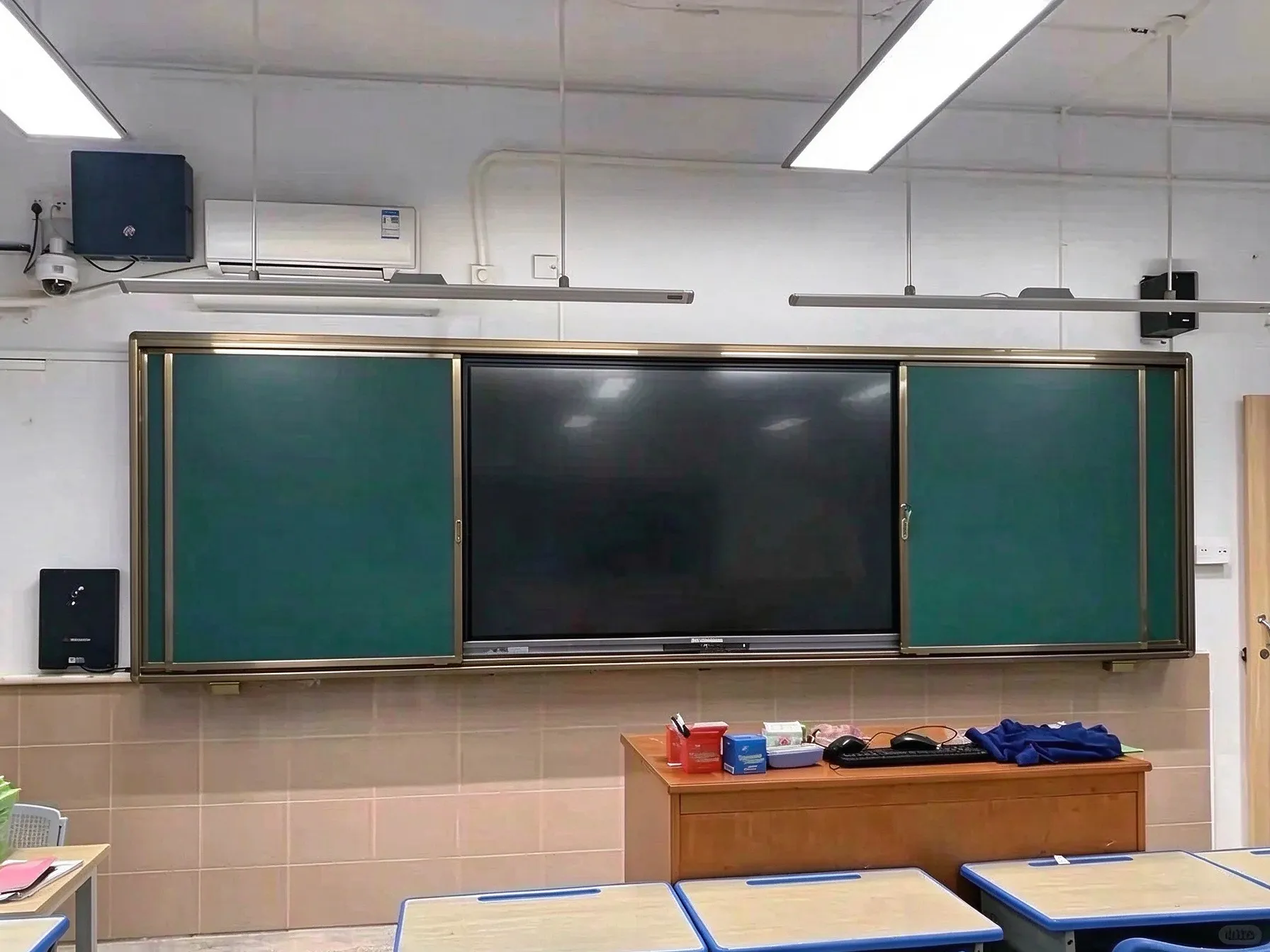 Interactive panel installed with sliding greenboard in a school classroom