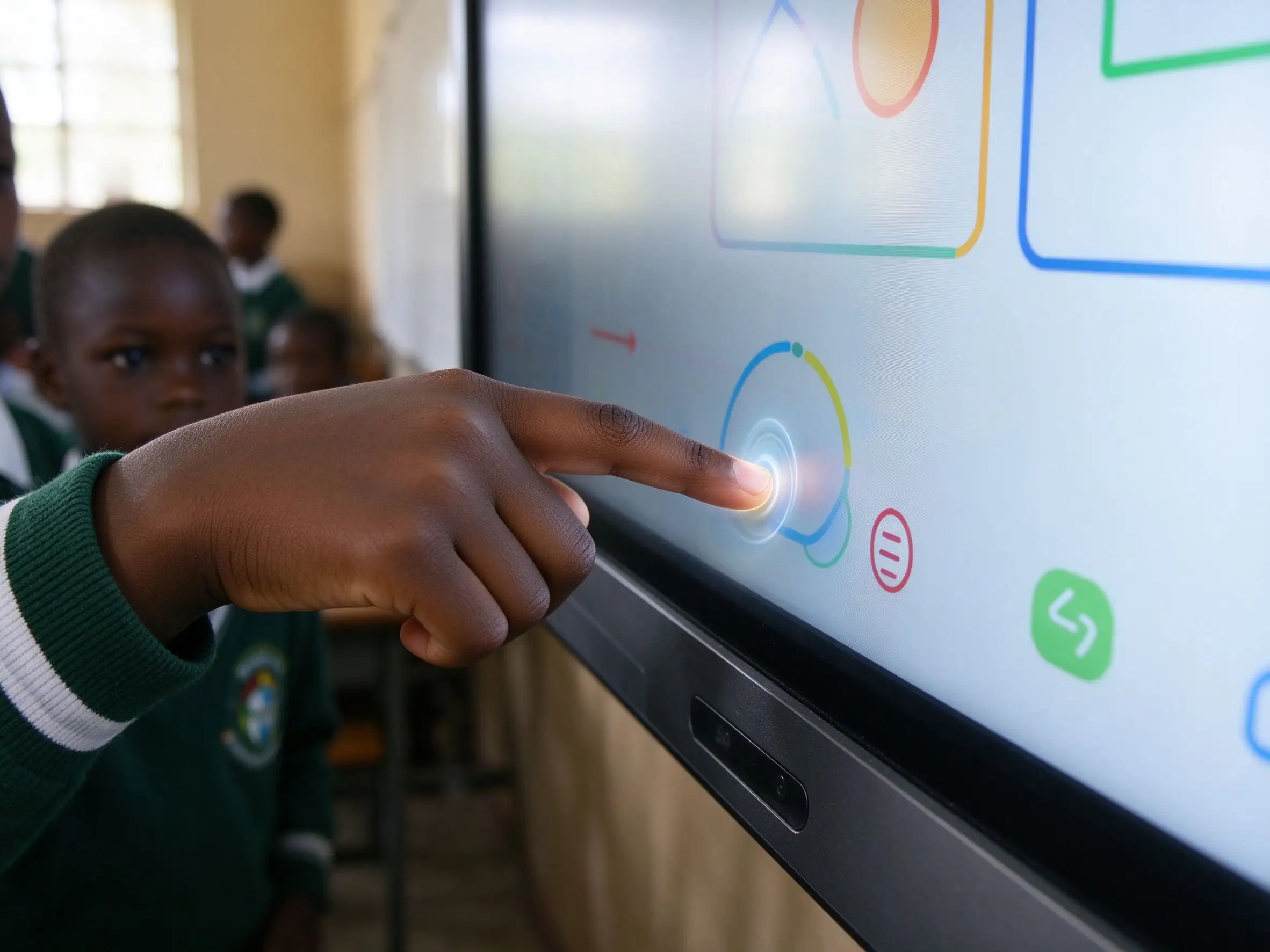 Child touching the interactive whiteboard screen